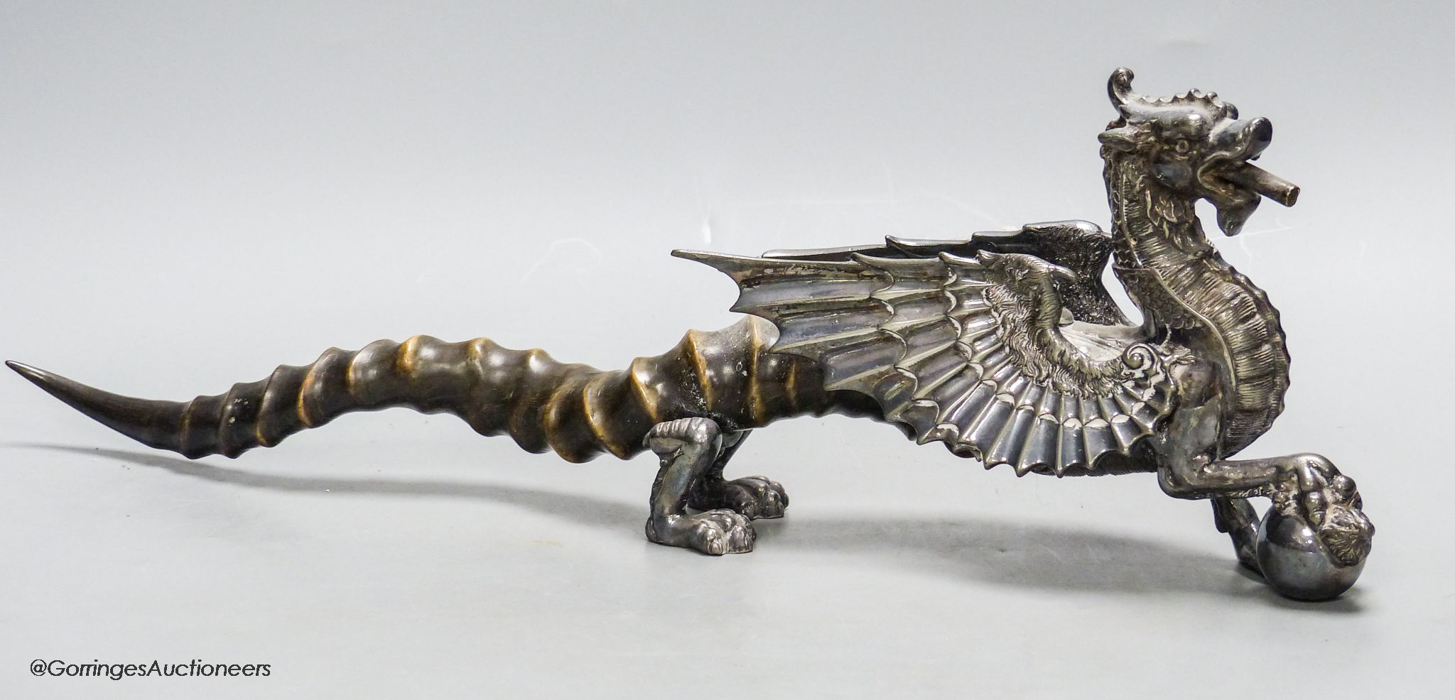 An Edwardian plated Welsh Dragon club lighter, with antler tail, length 46cm